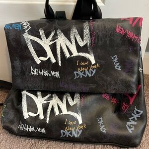 DKNY Graffiti fold over logo backpack.